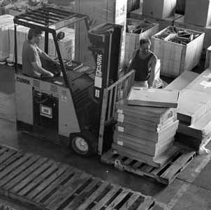 (left) Dennis McAuliff and Tom Smith load a forklift to prepare shipment to site 38