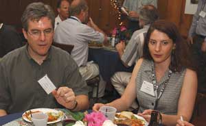 Fermilab physicist and CDF user Robin Erbacher (right) organized the Fermilab Users Meeting. Erbacher, sharing a table with John Conway of Rutgers, was pleasantly surprised by the interest people showed in the Washington situation with respect to support for high-energy physics.