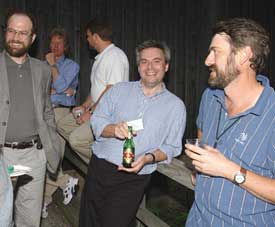 Fermilab users relaxed at the Kuhn Barn at the end of the day during the Annual Users Meeting. This DZero group consisted of (from left) Michael Fortner of Northern Illinois University (also the mayor of West Chicago), with co-spokesperson John Womersley and Harry Melanson of Fermilab.
