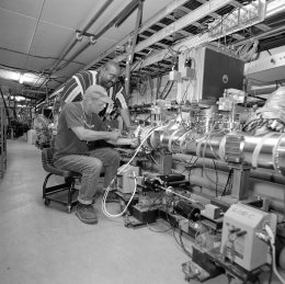 The installation of core cooling tanks in the Antiproton Source improved the antiproton beam properties, leading to better transfer efficiencies. Phil Crabtree (front) and Halbert Landers are two of the experts who worked on the project in June 2002.