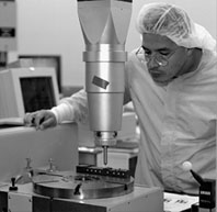 Technician Jorge Montes uses a coordinate measuring machine inthe Silicon Detector facility