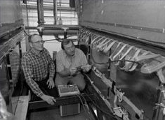 Indiana University physicist Tom Marshal and Fermilab engineer Boris Baldine make electronic checks of the DZero muon chamber
