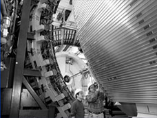University of Wisconsin physicists Yeondae and James Beringer examine the muon chamber on CDF's toroid