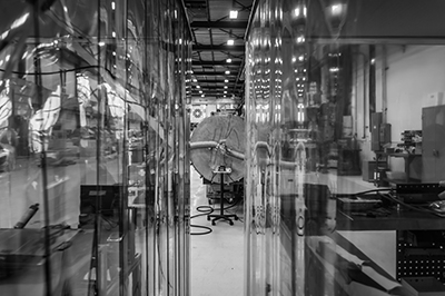 Looking through two areas of plastic room partitions, black and white